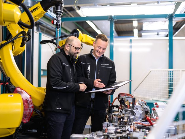 Programmierer und Projektleiter besprechen Roboteranlage bei LEWA Attendorn, Optimierung der Automatisierung